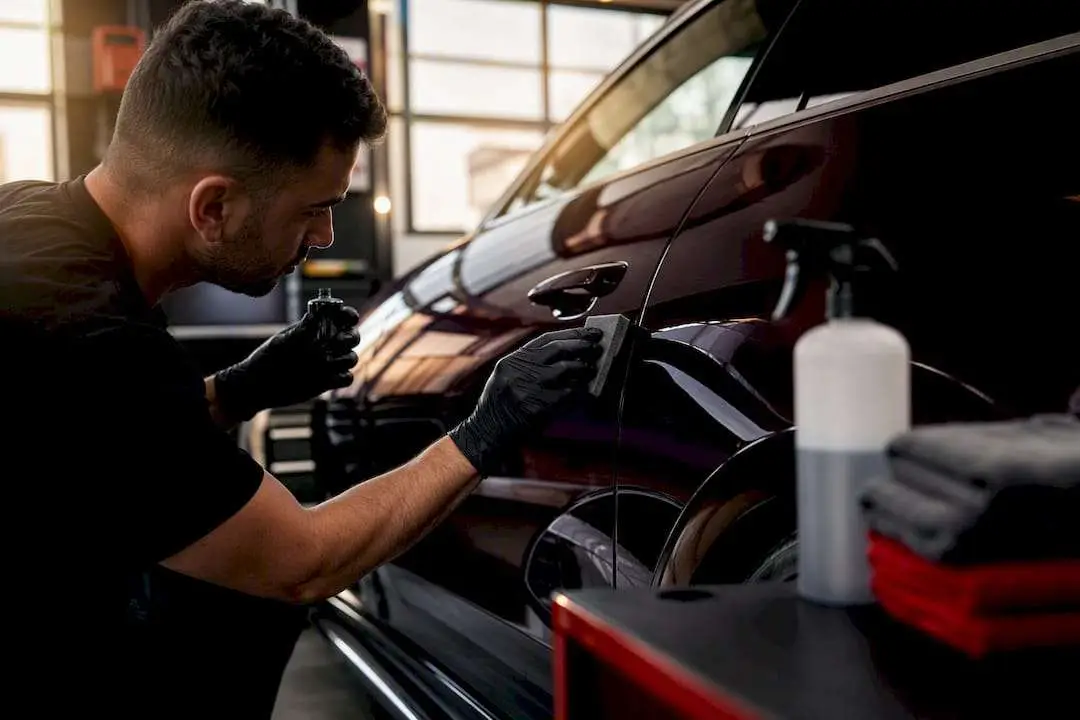 Technician polishing luxury car surface