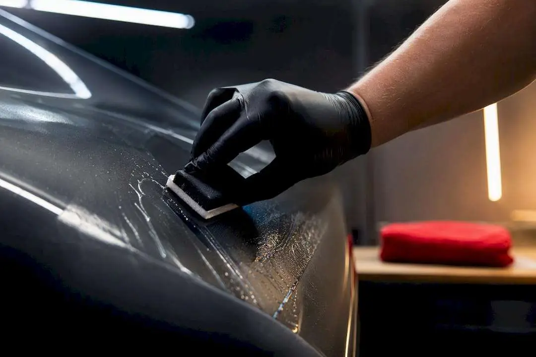 Technician applying coating over protective film