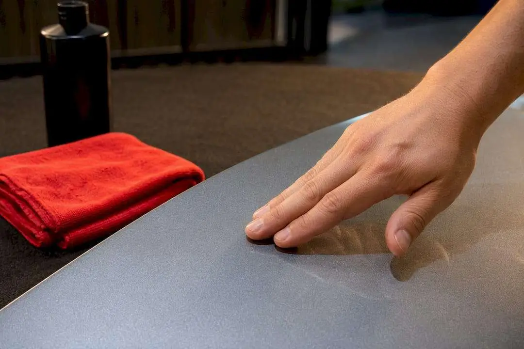 Technician checking paint smoothness by touch