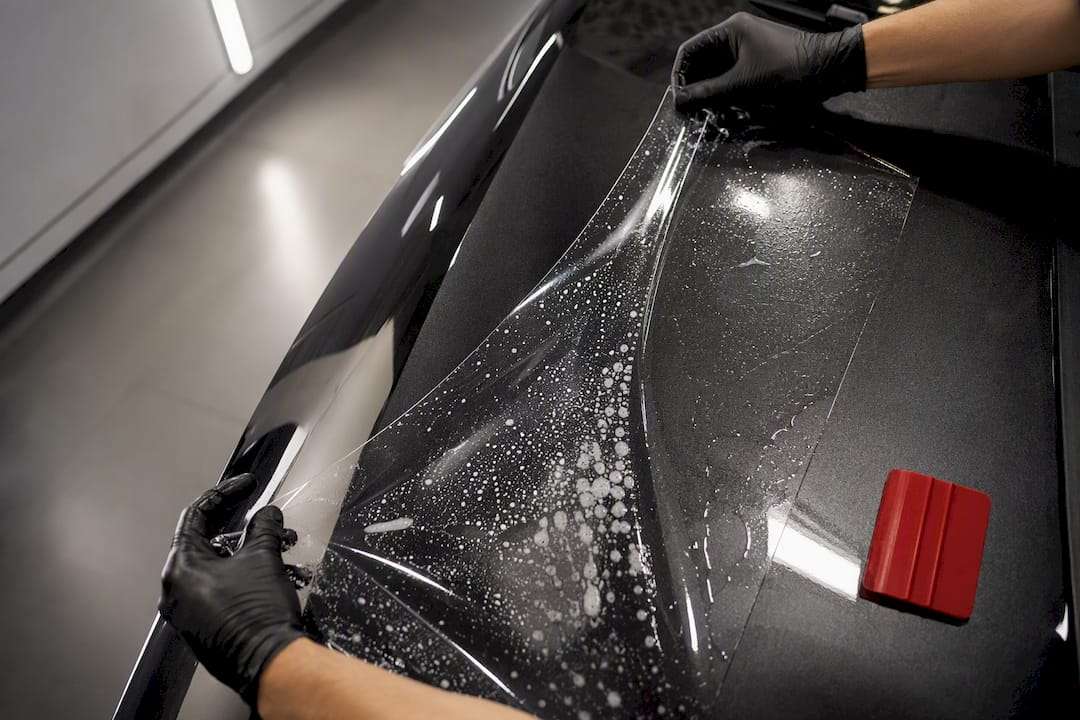 Technician aligning protection film in clean bay