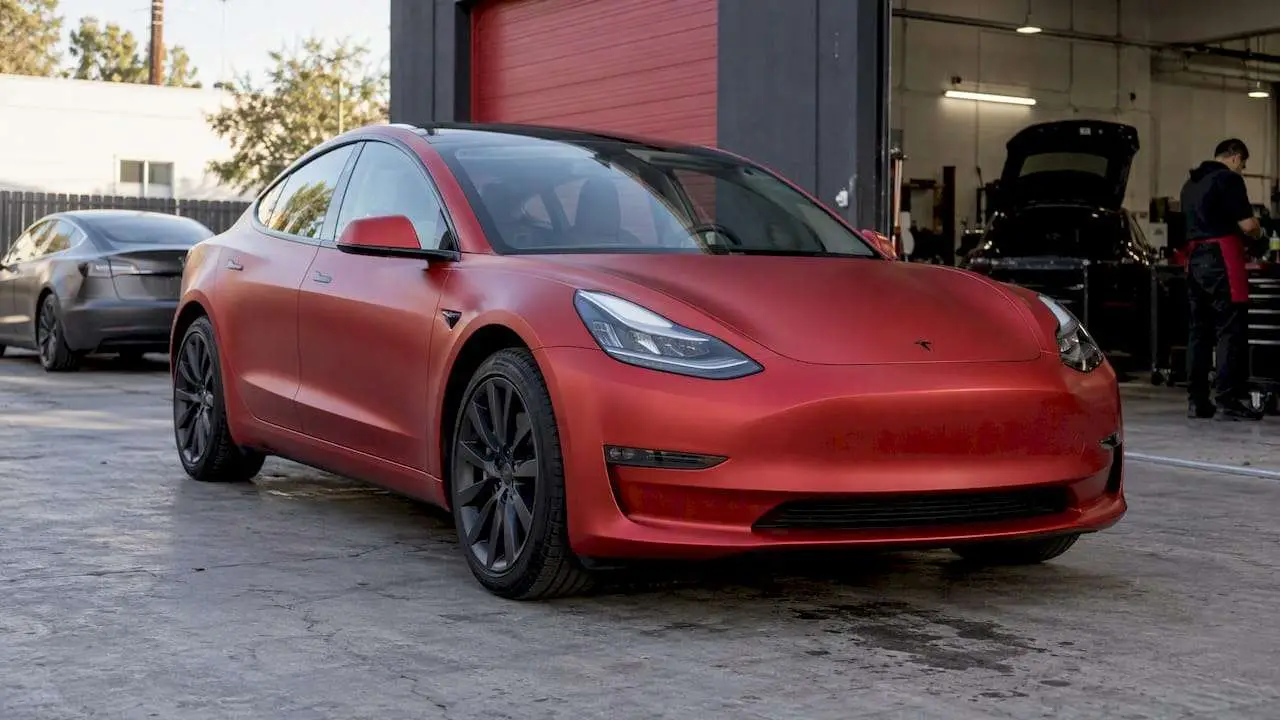 Finished satin-red Tesla outside styling shop